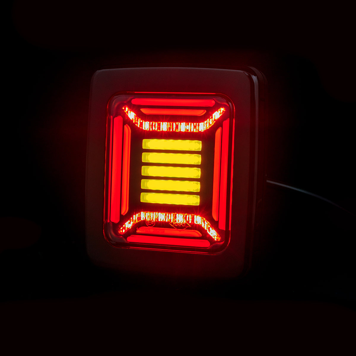 Red and yellow Horpol CUBE Rear Combination Lamp LED light on a black background
