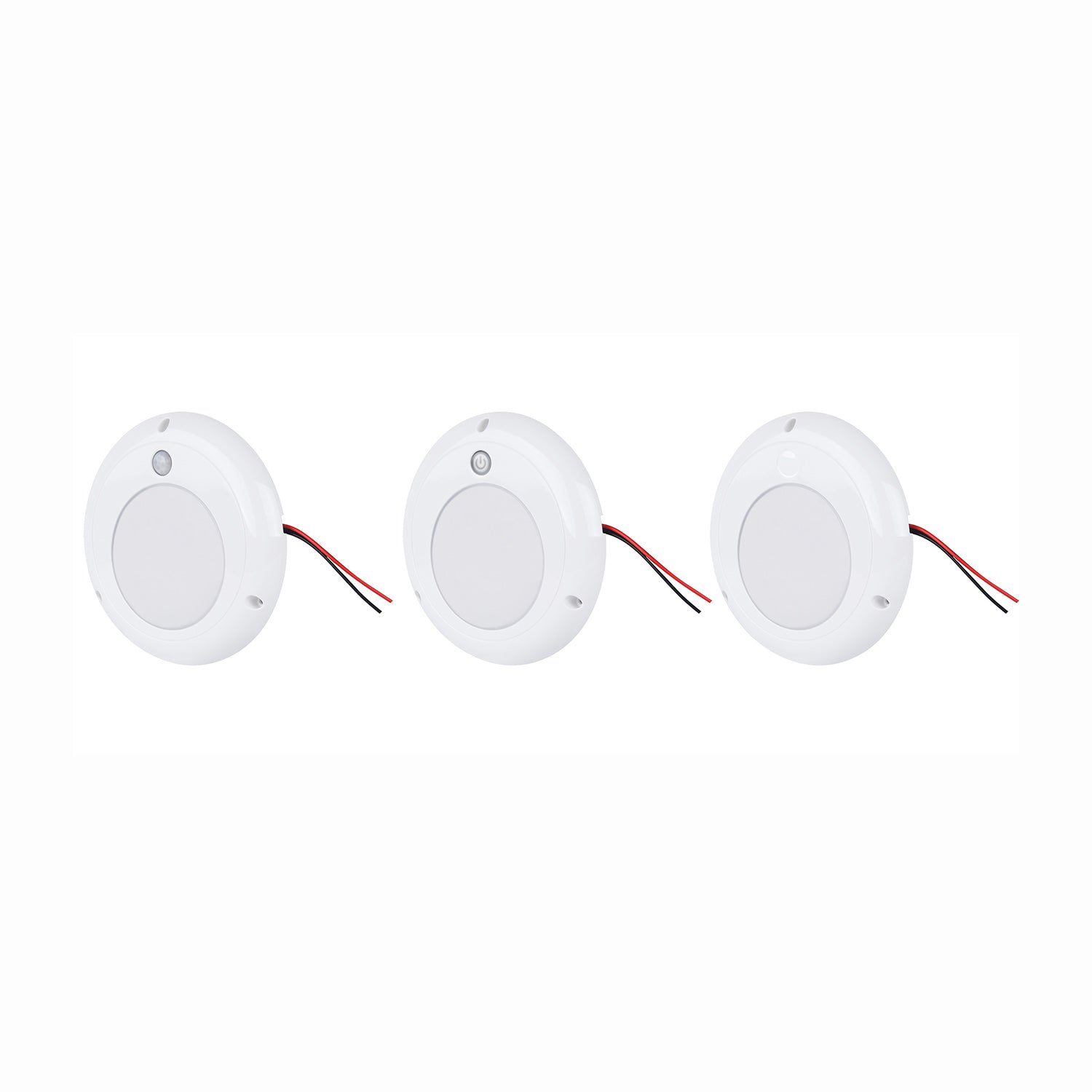 Three white LED puck lights with wires on a white background