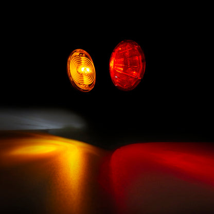 Two round lights, one yellow and one red, on a dark background.