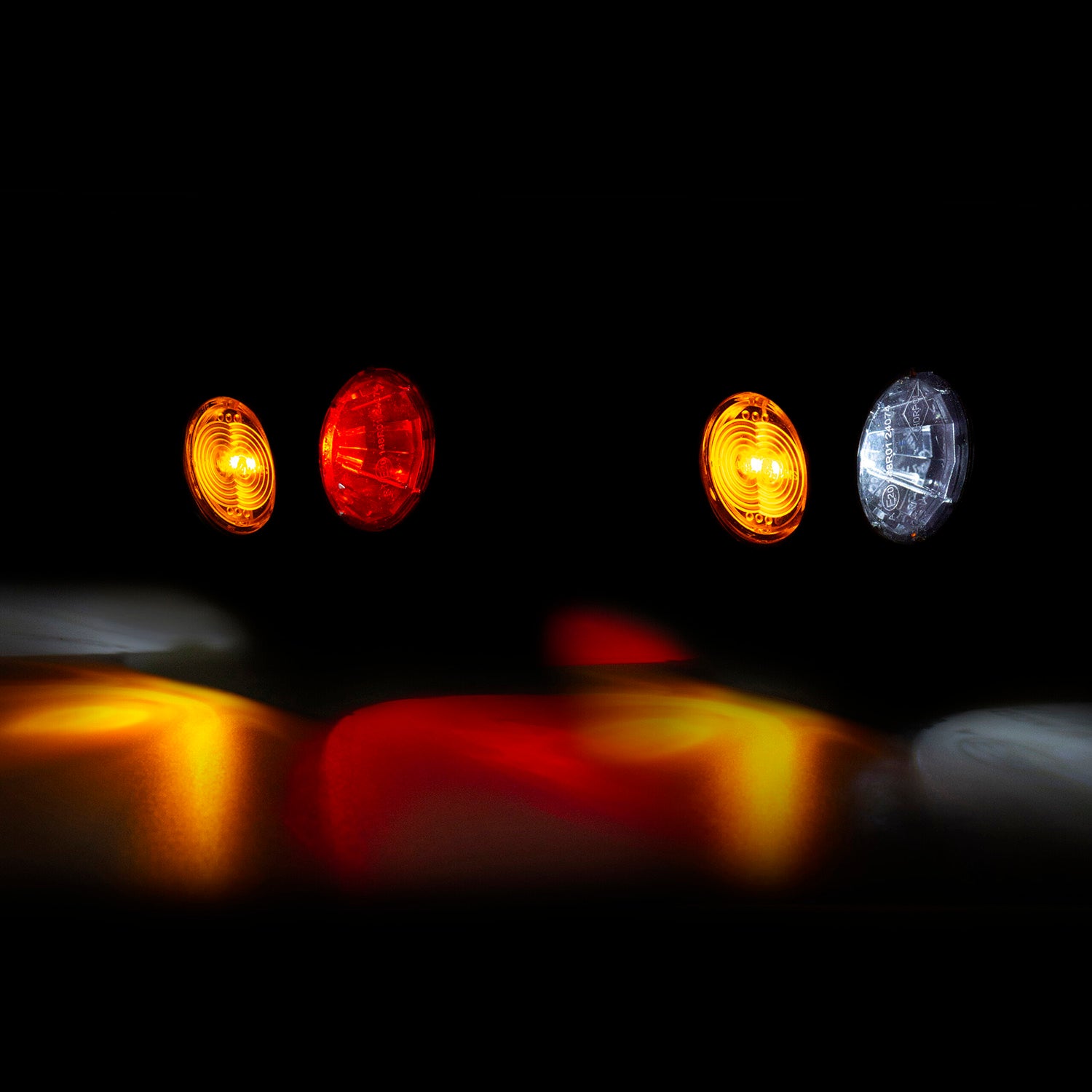 Four traffic lights in different colors on a black background